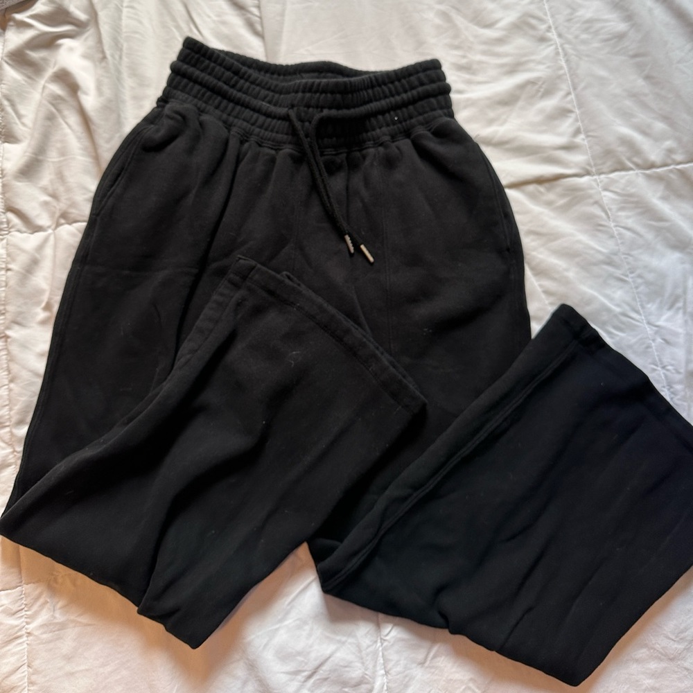 Straight leg black sweatpants , cut out at ankle